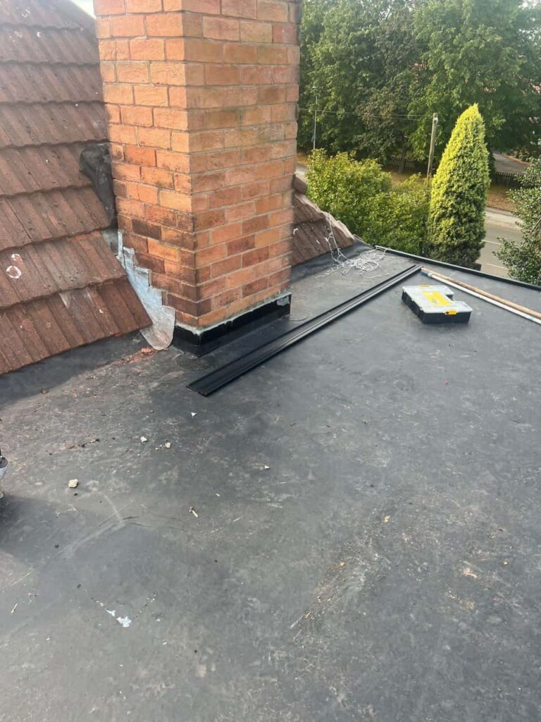 This is a photo of a flat roof which has just been repaired, there is also a chimney stack and some leadwork has also been dressed. Works carried out by Worksop Roofing Repairs